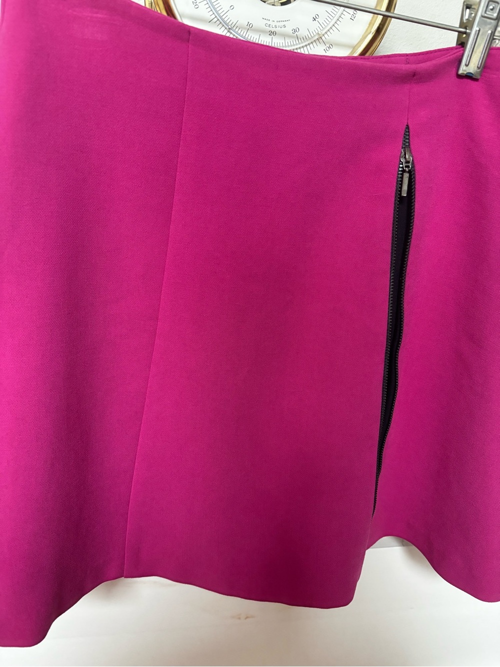 ASOS hot pink/fuchsia mini skirt prominent vertical side zipper detailing.